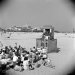 This photograph of the beach was taken in 1948. It shows a group of people watching a Punch and Judy show.