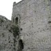 The 'floating' doorways and rows of holes in the walls next to them show that you are actually in what was a three storey building. Go into the tower and look for other clues to the building's use.